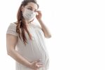 expectant mother white t shirt with protective mask against coronavirus her face Pregnancy and Covid-19: Staying safe during the Pandemic