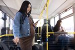 medium shot woman holding phone Tips to Travel During Pregnancy