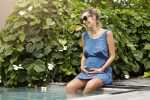beautiful young woman expecting child having rest swimming pool Maternity Swimwear: Embracing the Bump at the Beach